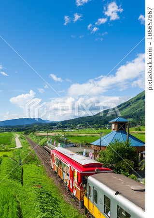 With the mountain range of Aso in the background, the tourist train Sunny Train and Minami Aso Water Village Hakusui Kogen Station "Minami Aso Railway, all lines open" With the mountain range of Aso in the background, the tourist train Sunny Train and Minami Aso Water Village Hakusui Kogen Station "Minami Aso Railway, all lines open" 106652667