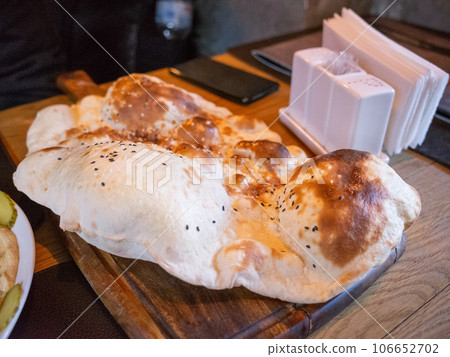 [Ukraine] A large, toasted and swollen bread served at a Turkish restaurant in the capital, Kyiv. 106652702