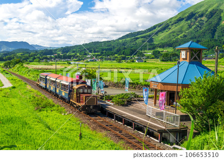 Sightseeing train with the mountain range of Aso in the background Torokko train Minami Aso water birth village Hakusui Kogen station "Minami Aso railway full line opening" 106653510