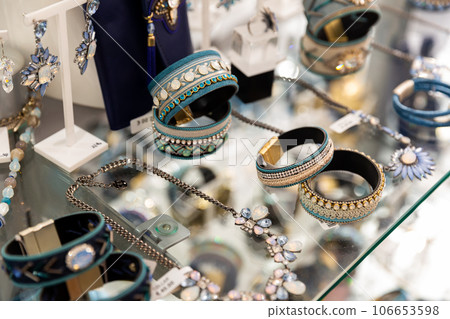 Various adornments on showcase in bijouterie shop Various adornments on showcase in bijouterie shop 106653598