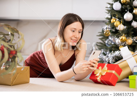 Happy woman is typing a message to someone on mobile Happy woman is typing a message to someone on mobile 106653725