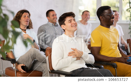 Group of positive men listening to a lecture 106653727