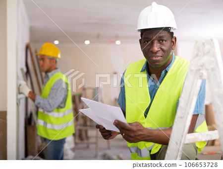 Portrait of foreman with documents in construction site Portrait of foreman with documents in construction site 106653728