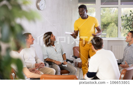 African American talking about study project to male classmates 106653801