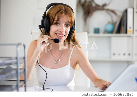 Call center operator talking with client and smiling Call center operator talking with client and smiling 106653885