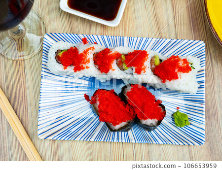 Urumaki roll with salmon avocado pepino and tobiko 106653959