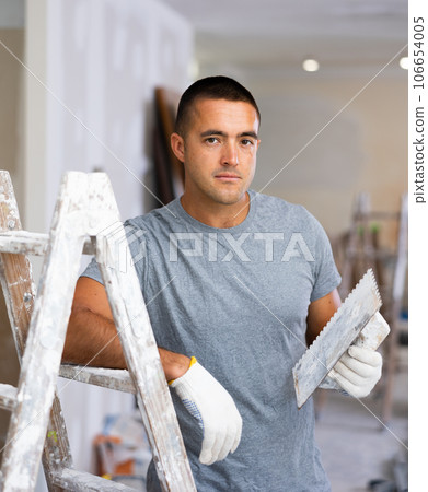Portrait of man in construction site with working tool 106654005