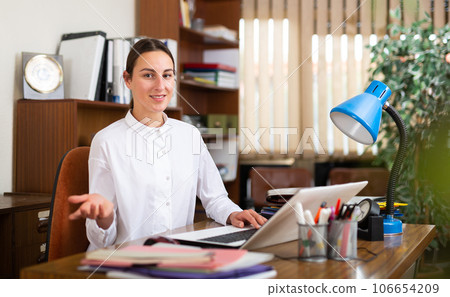 Young female business manager in the office is typing important documents on a computer Young female business manager in the office is typing important documents on a computer 106654209