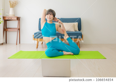 Instructor teaching yoga remotely Instructor teaching yoga remotely 106654854