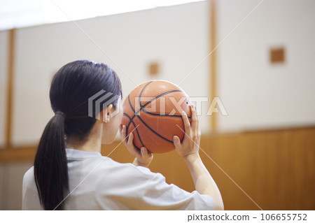 Japanese woman wearing sportswear practicing basketball at the gym 106655752