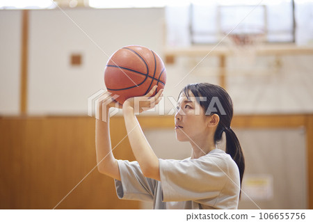 Japanese woman wearing sportswear practicing basketball at the gym Japanese woman wearing sportswear practicing basketball at the gym 106655756