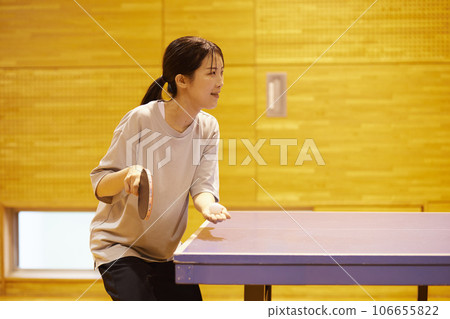 Japanese woman wearing sportswear practicing table tennis in the gym Japanese woman wearing sportswear practicing table tennis in the gym 106655822