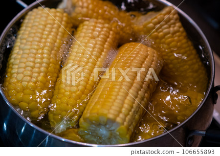 Home cooking boiled corn in a saucepan. Lots of sweet, tasty and boiled corn. Home cooking boiled corn in a saucepan. Lots of sweet, tasty and boiled corn. 106655893
