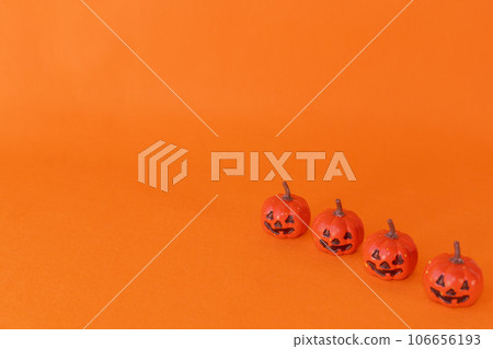 orange background and small jack o lantern 106656193