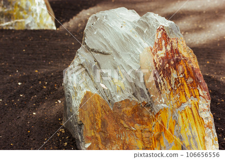 Texture of stone in a section close-up. Natural brown grey rock in a daylight. Abstract concrete weathered with cracks and scratches. Details of mountain stones. Rocks surface. Rocky landscape. 106656556