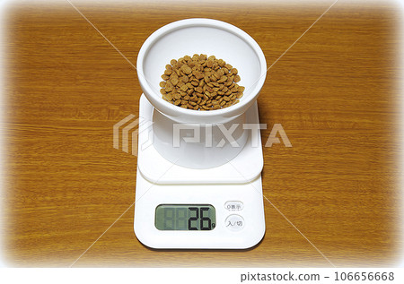 A container of cat food is placed on a digital scale that shows 26g (illustration style) A container of cat food is placed on a digital scale that shows 26g (illustration style) 106656668
