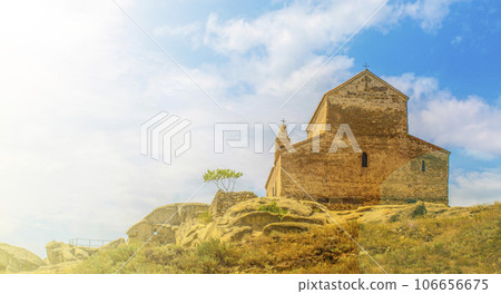 Back wall of old orthodox temple and blue sky in Georgia 106656675