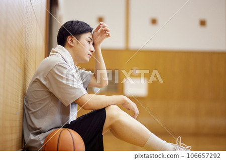 Japanese male university student practicing basketball in the gymnasium Japanese male university student practicing basketball in the gymnasium 106657292