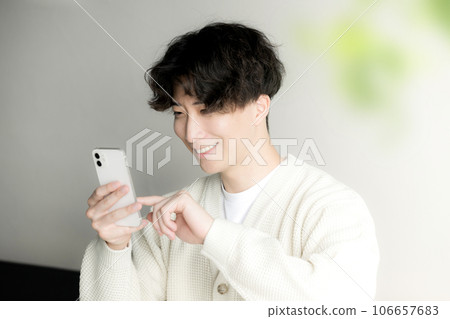 A man operating a smartphone taps A man operating a smartphone taps 106657683