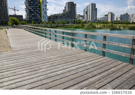 Wooden platform and fence on the shore of Lake Asperner in Vienna Wooden platform and fence on the shore of Lake Asperner in Vienna 106657838