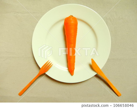 Carrots, knife and fork on a bright white plate Carrots, knife and fork on a bright white plate 106658046