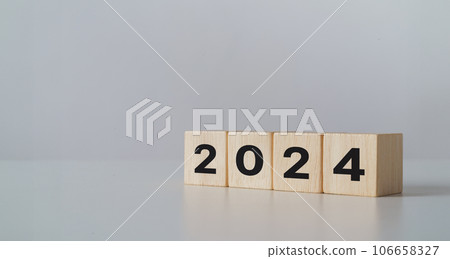 start to year 2024. wooden cube block with 2024 year text. happy new years concept. start to year 2024. wooden cube block with 2024 year text. happy new years concept. 106658327