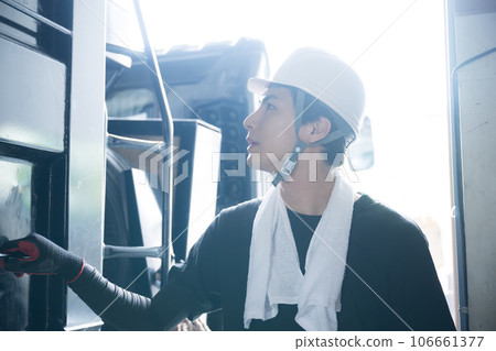 Image of a young man in work clothes, a truck driver Image of a young man in work clothes, a truck driver 106661377