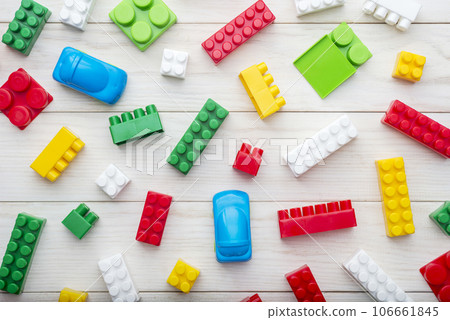 Colorful plastic toy blocks. Colorful plastic toy blocks on wooden background 106661845