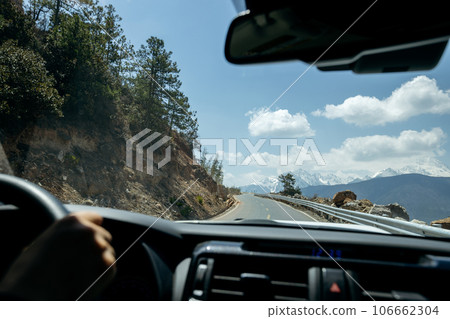 Driving car on the high altitude mountain trail, China 106662304