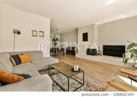 a living room with a couch, coffee table, and television on the wall in the room is very clean 106662384