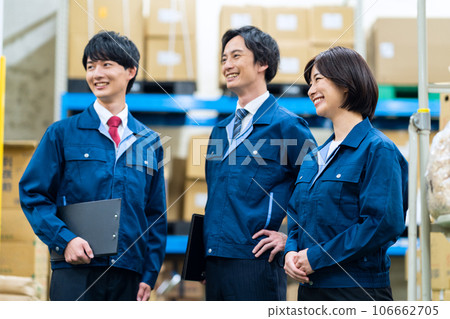 Male and female employees wearing work clothes working at a distribution center 106662705