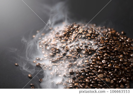 Closeup view of fresh roasted coffee beans with smoke Closeup view of fresh roasted coffee beans with smoke 106663553