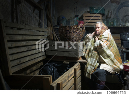 A woman hides in a cellar from shelling 106664733
