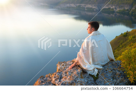 Young man sit on the hill 106664754