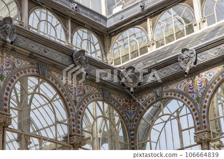 Crystal Palace (Palacio de cristal) in Retiro Park,Madrid, Spain. Is the main attraction of the park (built in 1887 by the architect Velazquez Bosco). Detail of the crystal palace. Crystal Palace (Palacio de cristal) in Retiro Park,Madrid, Spain. Is the main attraction of the park (built in 1887 by the architect Velazquez Bosco). Detail of the crystal palace. 106664839