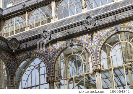 Crystal Palace (Palacio de cristal) in Retiro Park,Madrid, Spain. Is the main attraction of the park (built in 1887 by the architect Velazquez Bosco). Detail of the crystal palace. Crystal Palace (Palacio de cristal) in Retiro Park,Madrid, Spain. Is the main attraction of the park (built in 1887 by the architect Velazquez Bosco). Detail of the crystal palace. 106664841