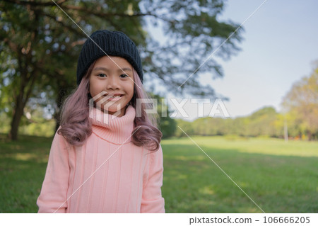 Asian woman waiting in the garden. She was smiling with confidence. Asian woman waiting in the garden. She was smiling with confidence. 106666205