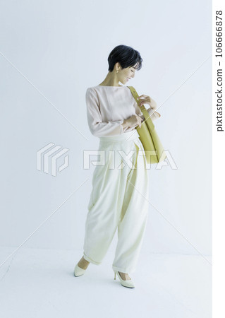 Full body fashion portrait of a young woman on a white background, vertical position 106666878
