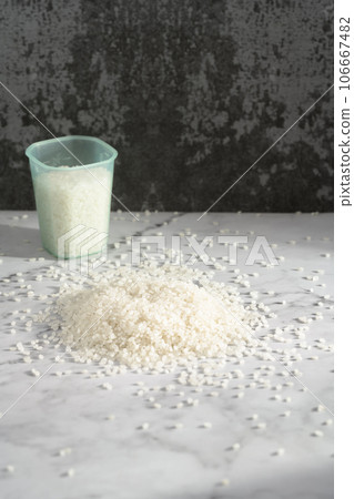 fresh raw organic rice in a plastic cup 106667482