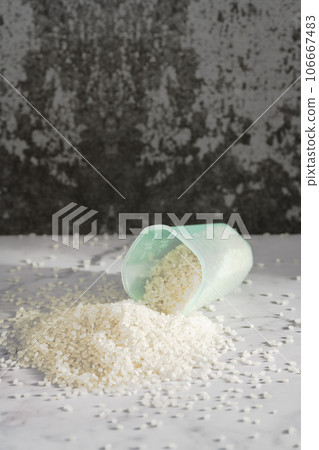 fresh raw organic rice in a plastic cup 106667483