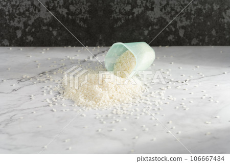 fresh raw organic rice in a plastic cup 106667484