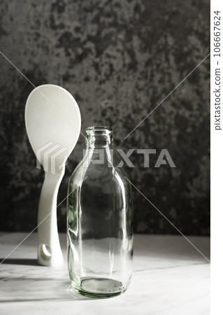 empty glass bottles on a dark background 106667624