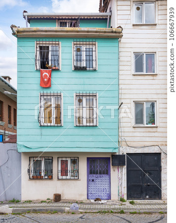 Wooden traditional residential building with a Turkish flag hanging from its window, Uskudar district, Istanbul, Turkey Wooden traditional residential building with a Turkish flag hanging from its window, Uskudar district, Istanbul, Turkey 106667939