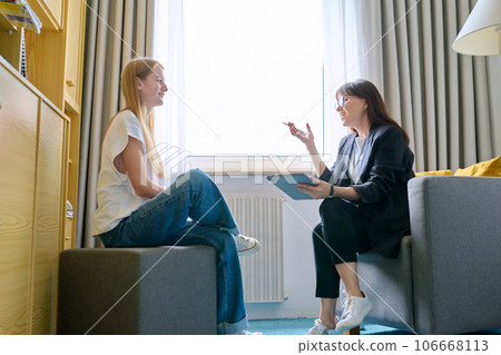 Young female at therapy meeting with psychotherapist Young female at therapy meeting with psychotherapist 106668113