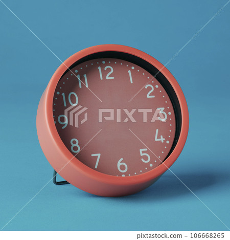 pink clock without hands on a blue background 106668265