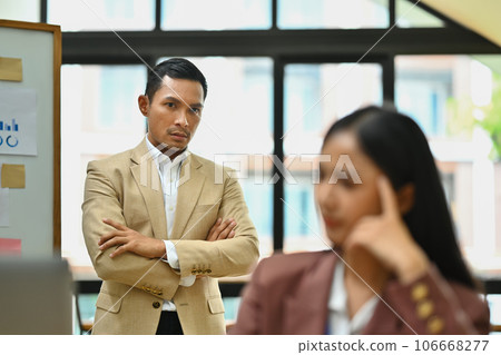 Strict millennial male boss look at stressed female employee at workplace, find mistake in office interior 106668277