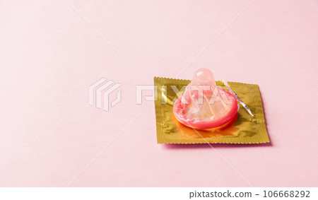 World sexual health or Aids day, Top view flat lay condom in wrapper pack is tear open, studio shot isolated on a pink background, Safe sex and reproductive health concept World sexual health or Aids day, Top view flat lay condom in wrapper pack is tear open, studio shot isolated on a pink background, Safe sex and reproductive health concept 106668292