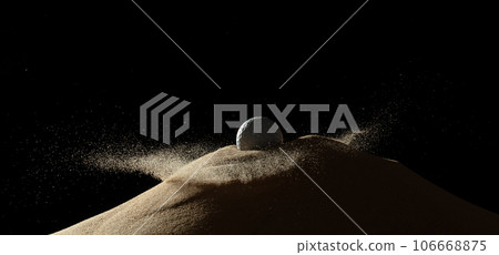 Golf ball tee explode from sand bunker. Golfer hit ball with club to sand explosion to green. Golf club hit ball tee in sand wedge bunker explosion. Black background isolated freeze motion 106668875