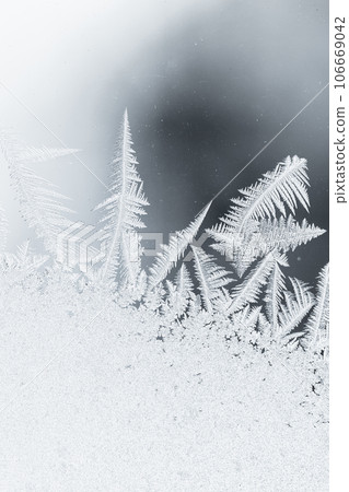 Frost pattern on glass, macro photo, natural winter background Frost pattern on glass, macro photo, natural winter background 106669042