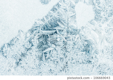 Frost pattern over a window glass, macro photo Frost pattern over a window glass, macro photo 106669043